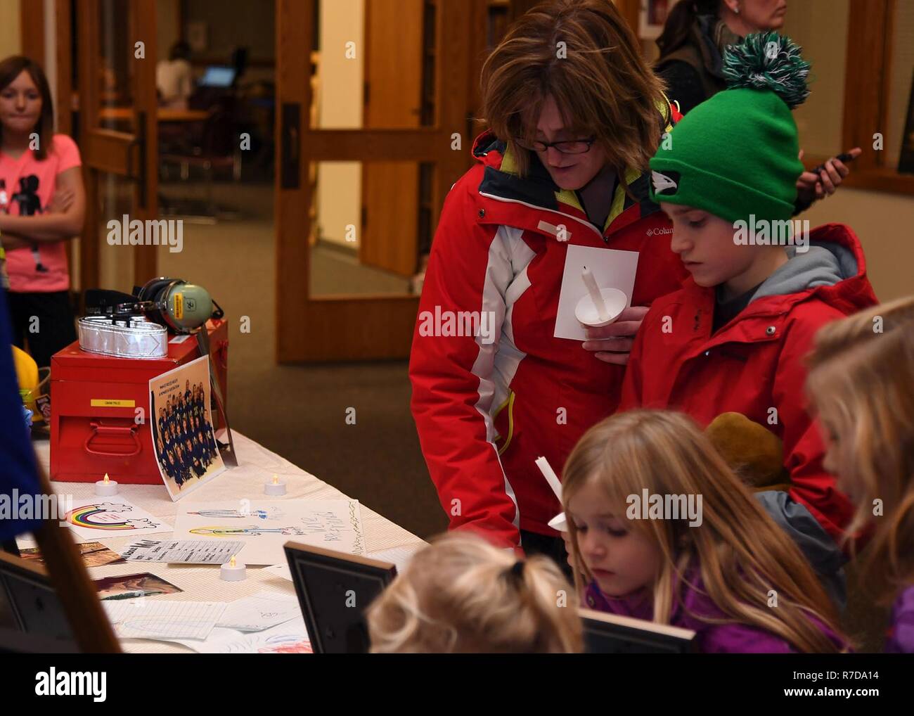 Familien, die eine Mahnwache für den Dekan Familie stop ein Denkmal Tabelle anzeigen 28. November 2018 besucht, in der St. Timothy Katholische Kirche, Manvel, North Dakota. Staff Sgt. Anthony James Dean, seine Frau Chelsi Kay Dean, und ihren zwei Kindern Kaytlin Merie Dean, 5 und Avri James Dean, 1, in einem Autounfall in der Nähe von Billings, Montana getötet wurden, während des Thanksgiving. Stockfoto