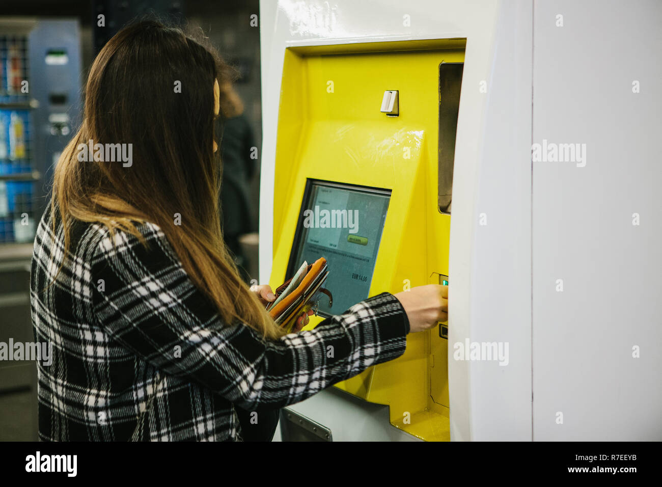 Das Mädchen kauft ein Ticket in der U-Bahn in ein spezielles Ticket Maschine in Berlin in Deutschland. Stockfoto