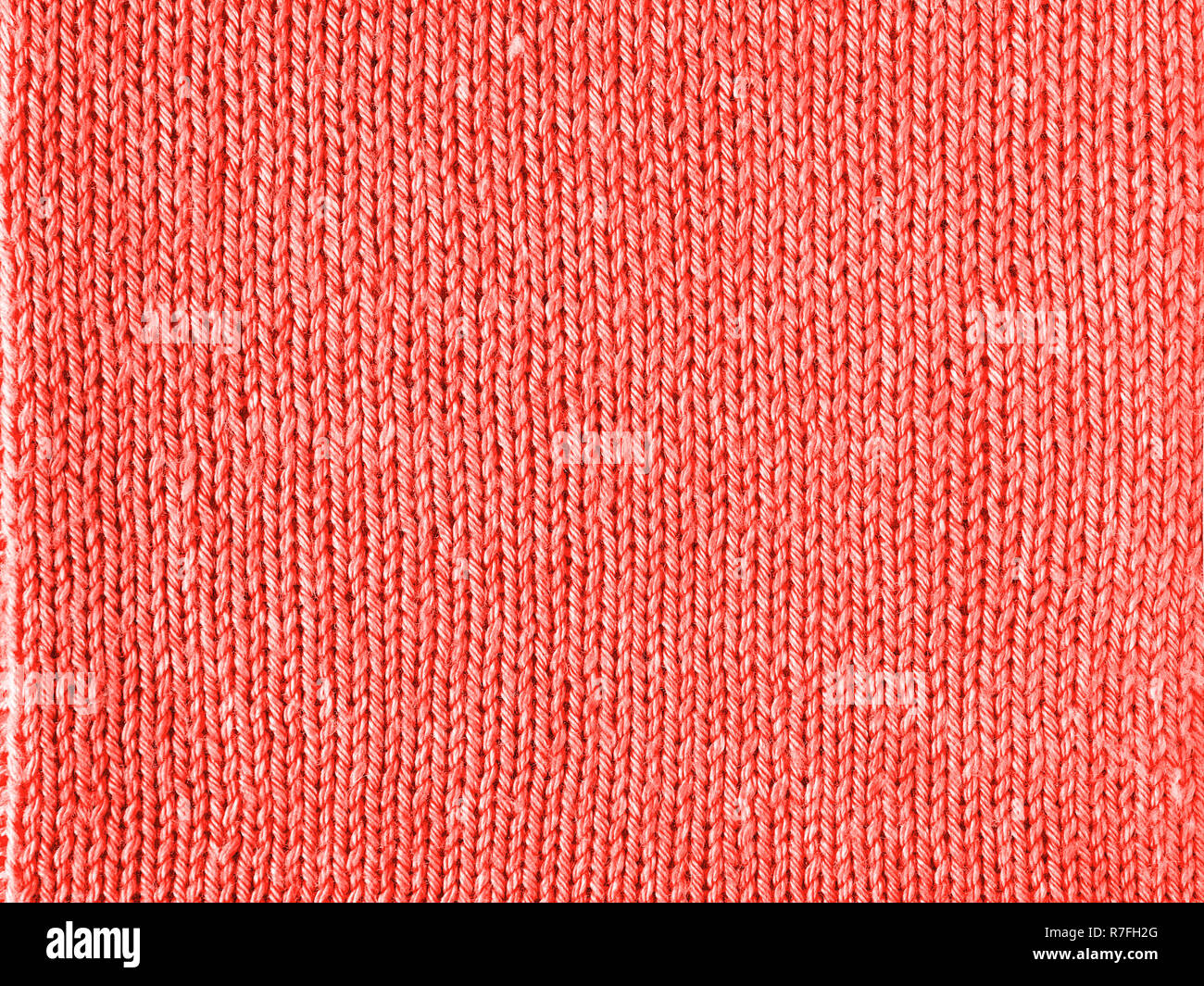 Lebende Koralle Farbe gestrickt Jersey als Background. Gestrickt, lebende Korallen Textur. Farbe des Jahres 2019. Stockfoto