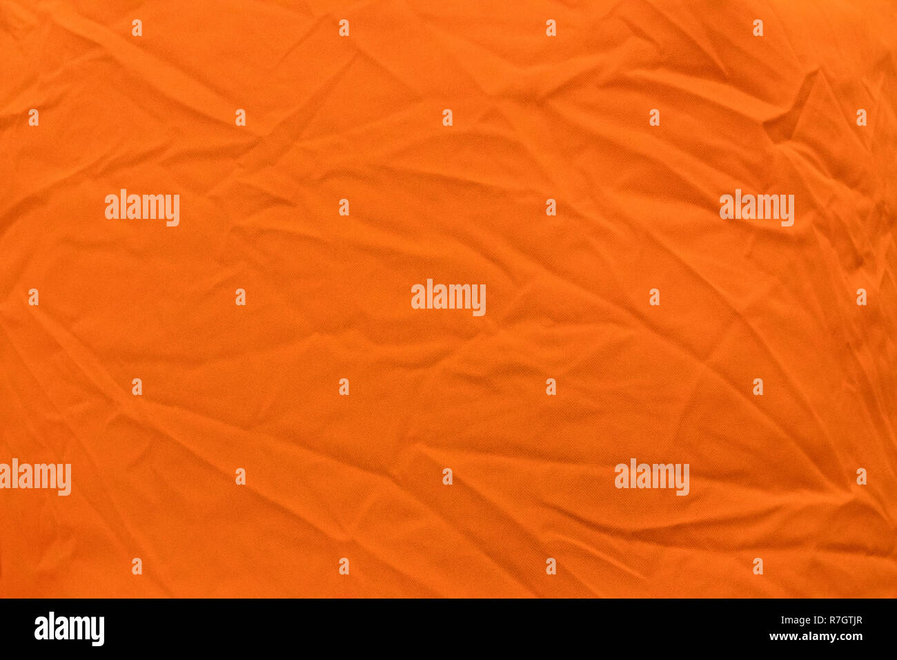 Helles orange Stoff mit leichten Falten closeup, können als Hintergrund oder Textur verwendet werden. Stockfoto