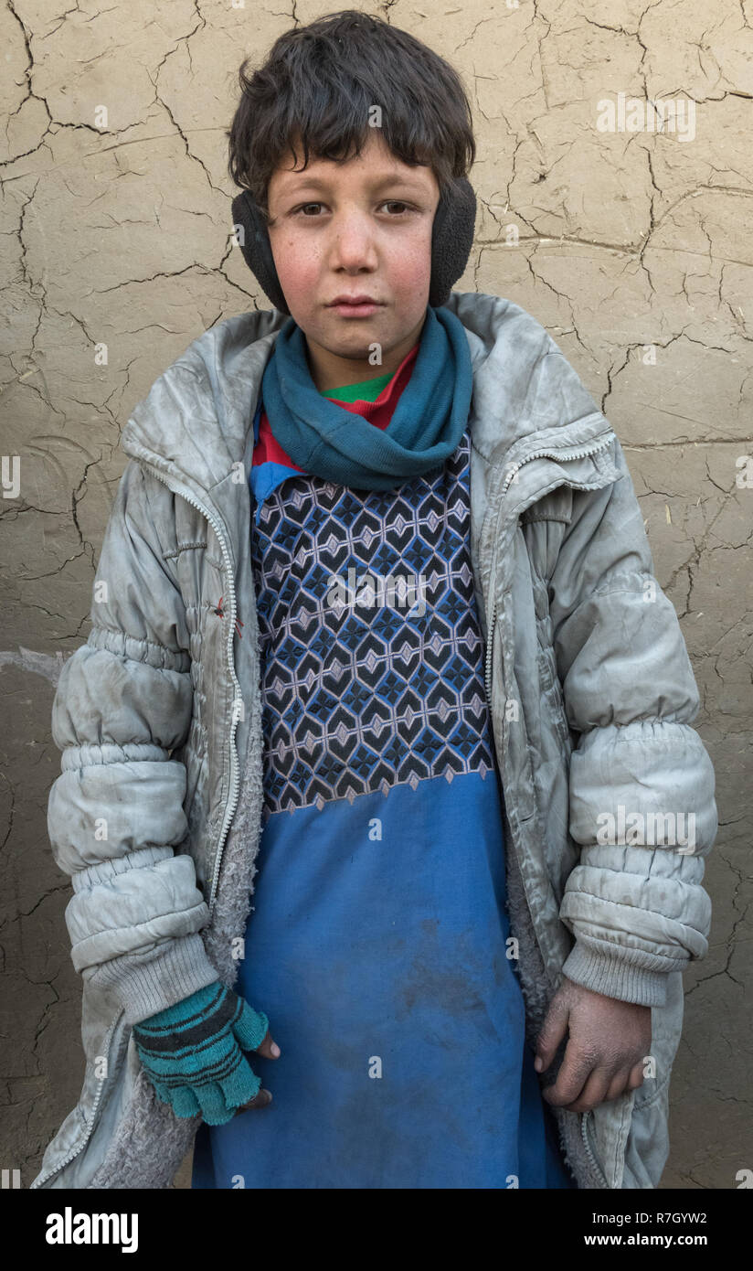 Junge, dessen Familie aus der Provinz Helmand durch die Taliban vertrieben worden. Er lebt in schwierigen Bedingungen in einem Flüchtlingslager in der Nähe von Kabul, Afghanistan. Stockfoto