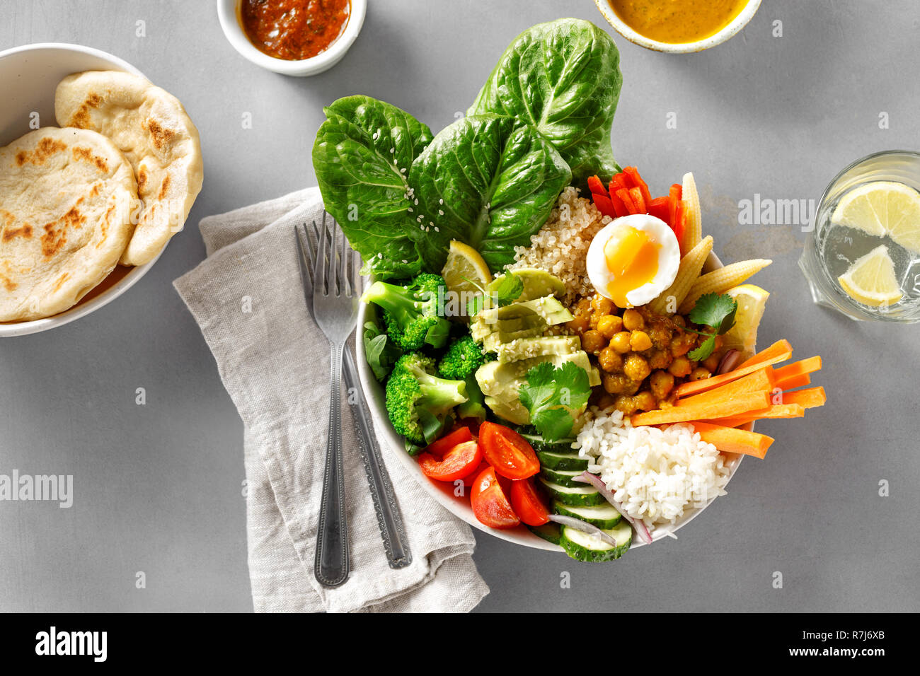 Buddha Schüssel mit Naan Brot auf grauem Beton Hintergrund der Ansicht von oben. Gesunde Ernährung Konzept Stockfoto