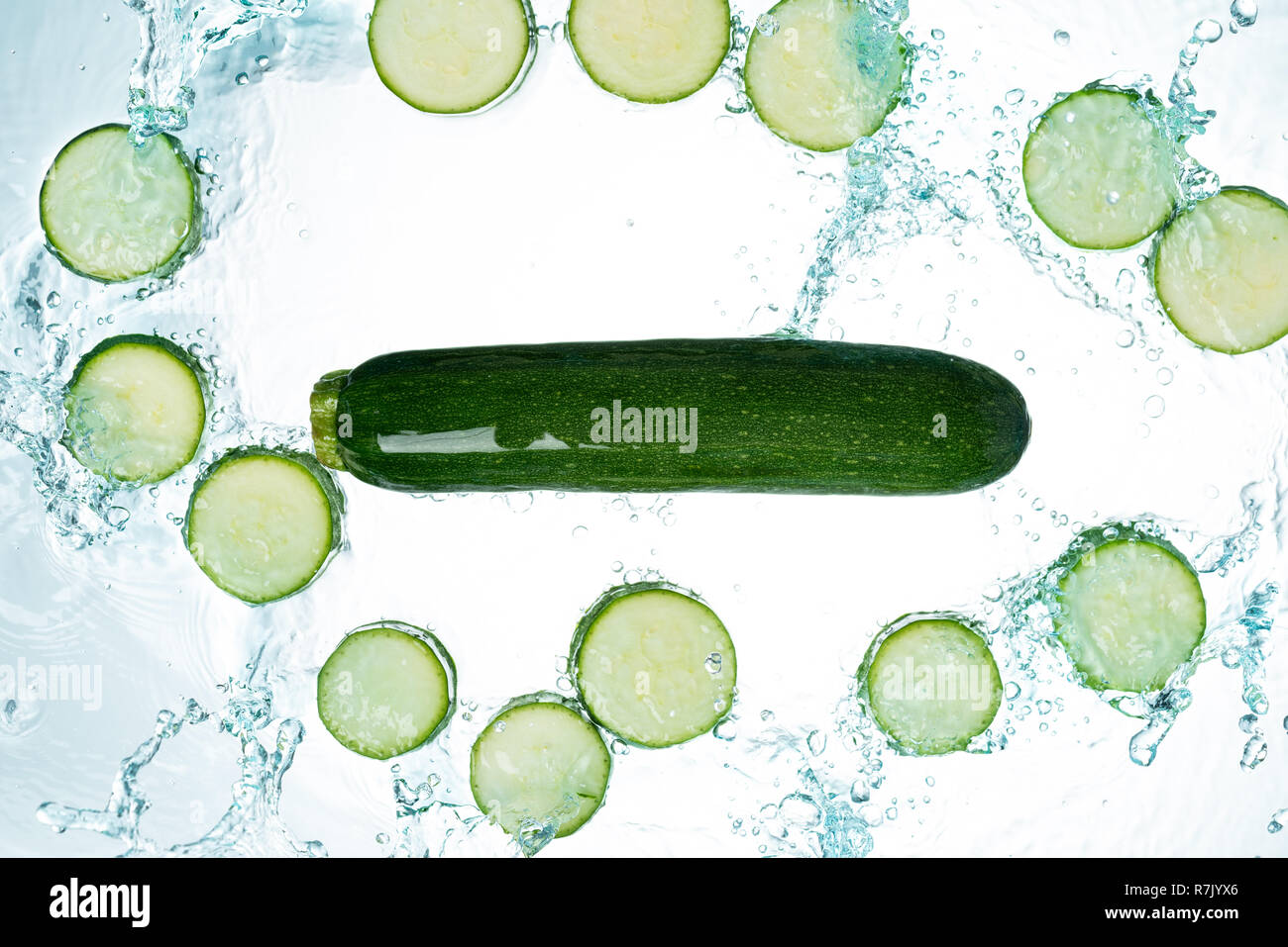 Zucchini Spritzwasser auf weißem Hintergrund Stockfoto
