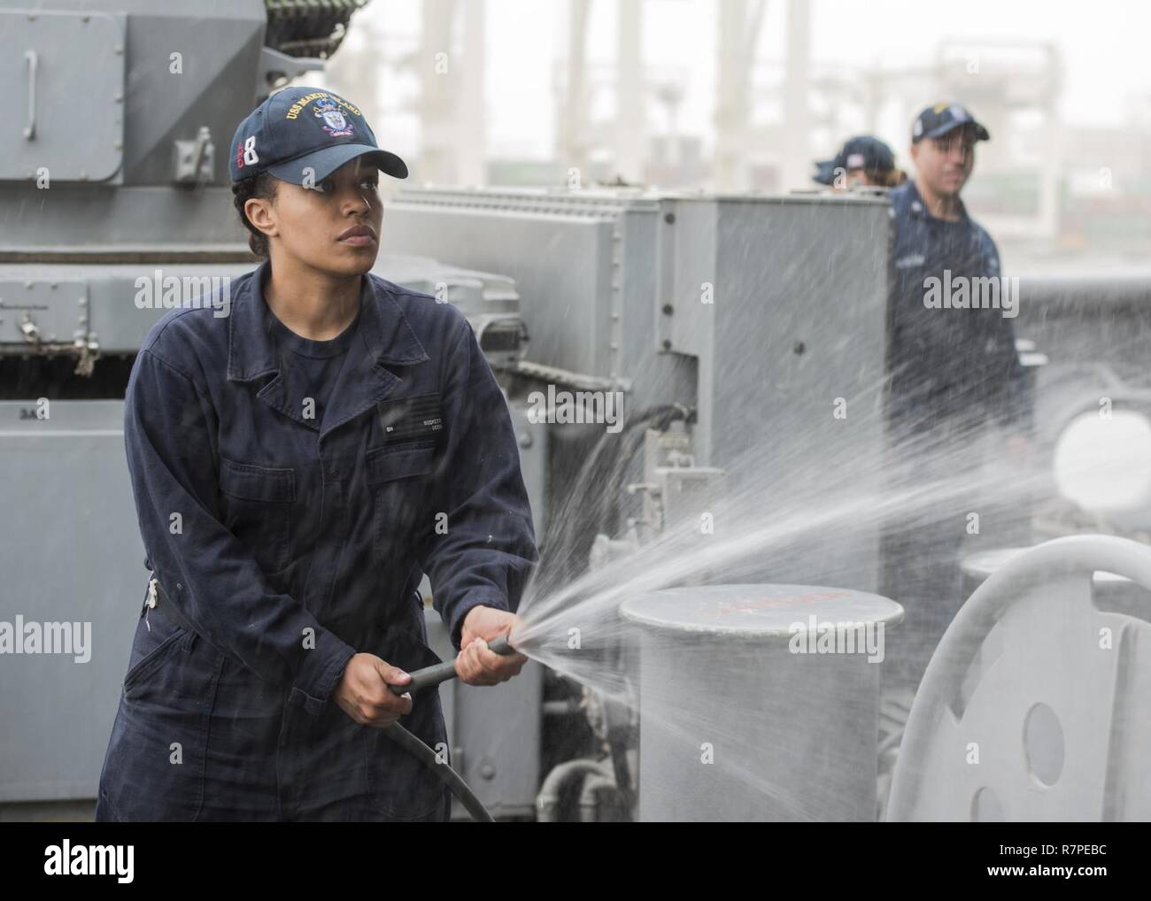 5. US-Flotte von Operationen (21. März 2017) Seaman Jayelin Beckett, aus San Antonio, Texas, Schläuche, die fantail der USS Makin Island (LHD 8) als Amphibisches Schiff unterwegs nach einem Hafen besuch in Jebel Ali, Vereinigte Arabische Emirate. Makin Island ist in den USA der 5. Flotte Bereich für Maßnahmen zur Erhöhung der Sicherheit des Seeverkehrs auf die Verbündeten und Partnern zu beruhigen bereitgestellt, und der Freiheit der Schiffahrt und des freien Handels in der Region erhalten. Stockfoto