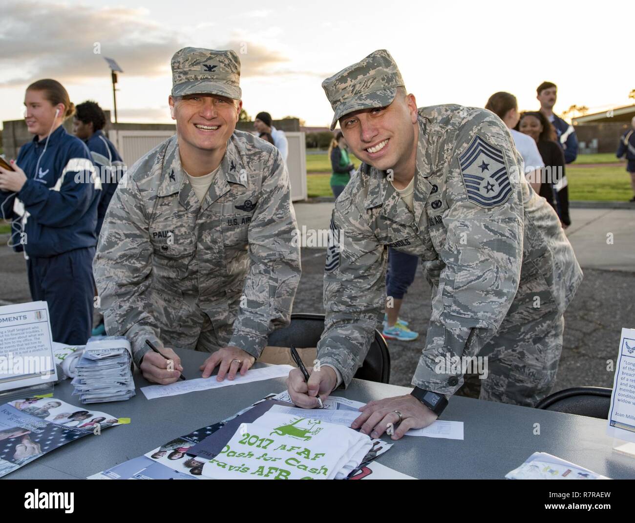 Us Air Force Colonel Thomas Pauly, 60th Air Mobility Wing Stellvertretender Kommandeur und Chief Master Sgt. Steve Nichols, 60 AMW Befehl Chief, melden Beitrag Zusagen während der Air Force (AFAF) Kick off und Fun Run, 27.03.2017, Travis Air Force Base, Calif. Mehr als 200 Menschen an dem Ereignis stattfand, Bewußtsein über die AFAF Mission zu heben teilgenommen; Unterstützung der Air Force Familien in Not, für Active Duty, Rentner, Reservisten, Guard, Angehörige und überlebende Ehegatten. Stockfoto