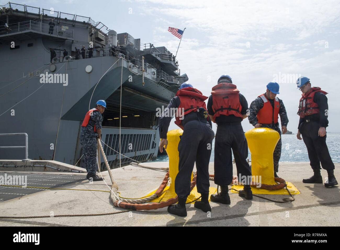 OKINAWA, Japan (6. April 2017) Pierside line-Handler Moor die Amphibious Assault ship USS BONHOMME RICHARD (LHD6) während der Ankunftszeit des Schiffes zu weißen Strand Marinestützpunkt Marines an Bord der 31 Marine Expeditionary Unit. Bonhomme Richard, dem Flaggschiff der Bonhomme Richard amphibischen bereit, Gruppe, ist auf eine Patrouille, die in der Indo-Asia - Pazifik Region warfighting Bereitschaft und Haltung als ready-Response Force für jede Art der Kontingenz zu verbessern. Stockfoto