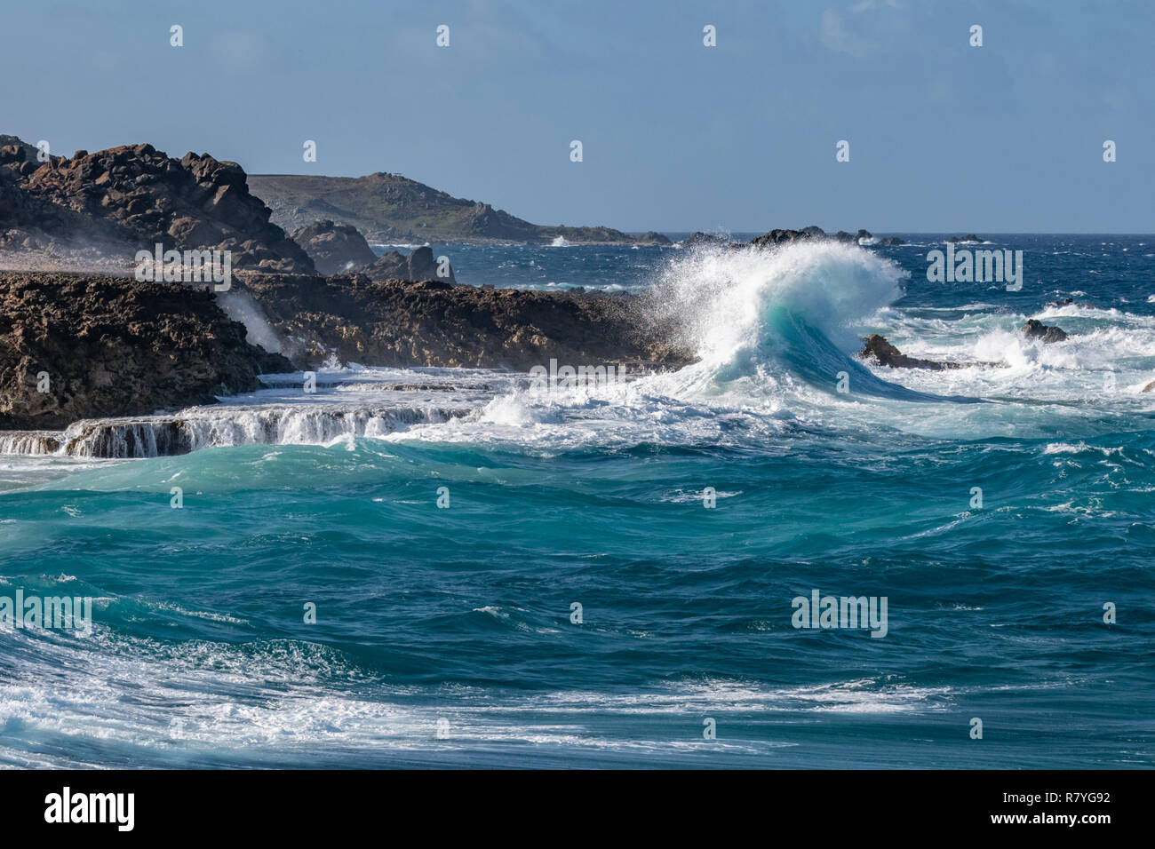 "Arikok" Nationalpark - Wellen, die in einen Felsen - aquamarin Blue waves Crash in Felsen an der Küste von Aruba-Dos Playa Beach Stockfoto
