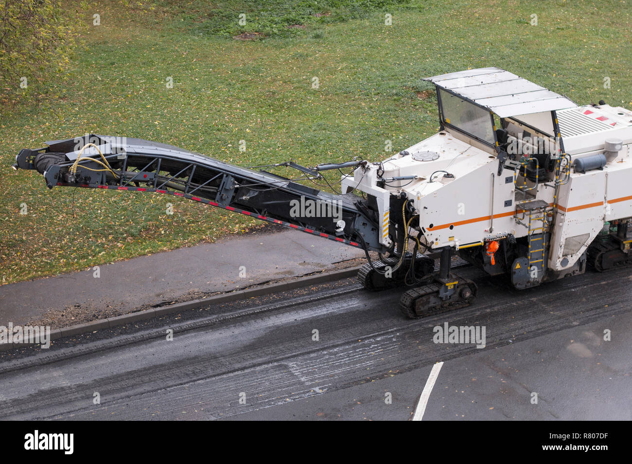 Straßenfräse in Erwartung eines Dump Truck. Straße Reparatur. Stockfoto