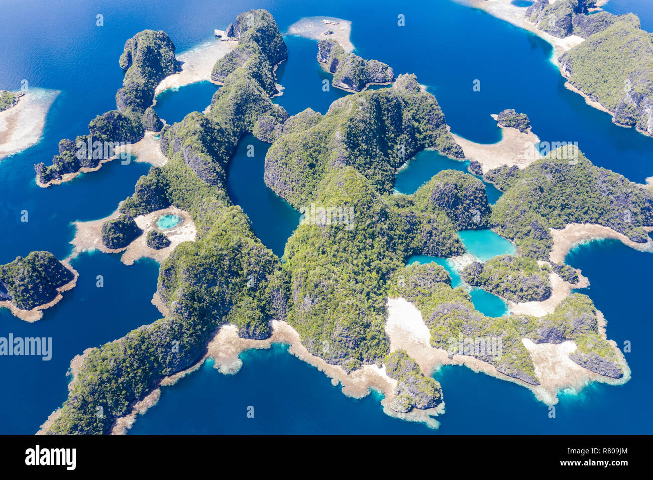 Flachen Korallenriffen umgeben remote Kalkstein Inseln in Raja Ampat, Indonesien. Diese artenreichen Region wird als das "Herz der Korallen Dreieck bekannt." Stockfoto