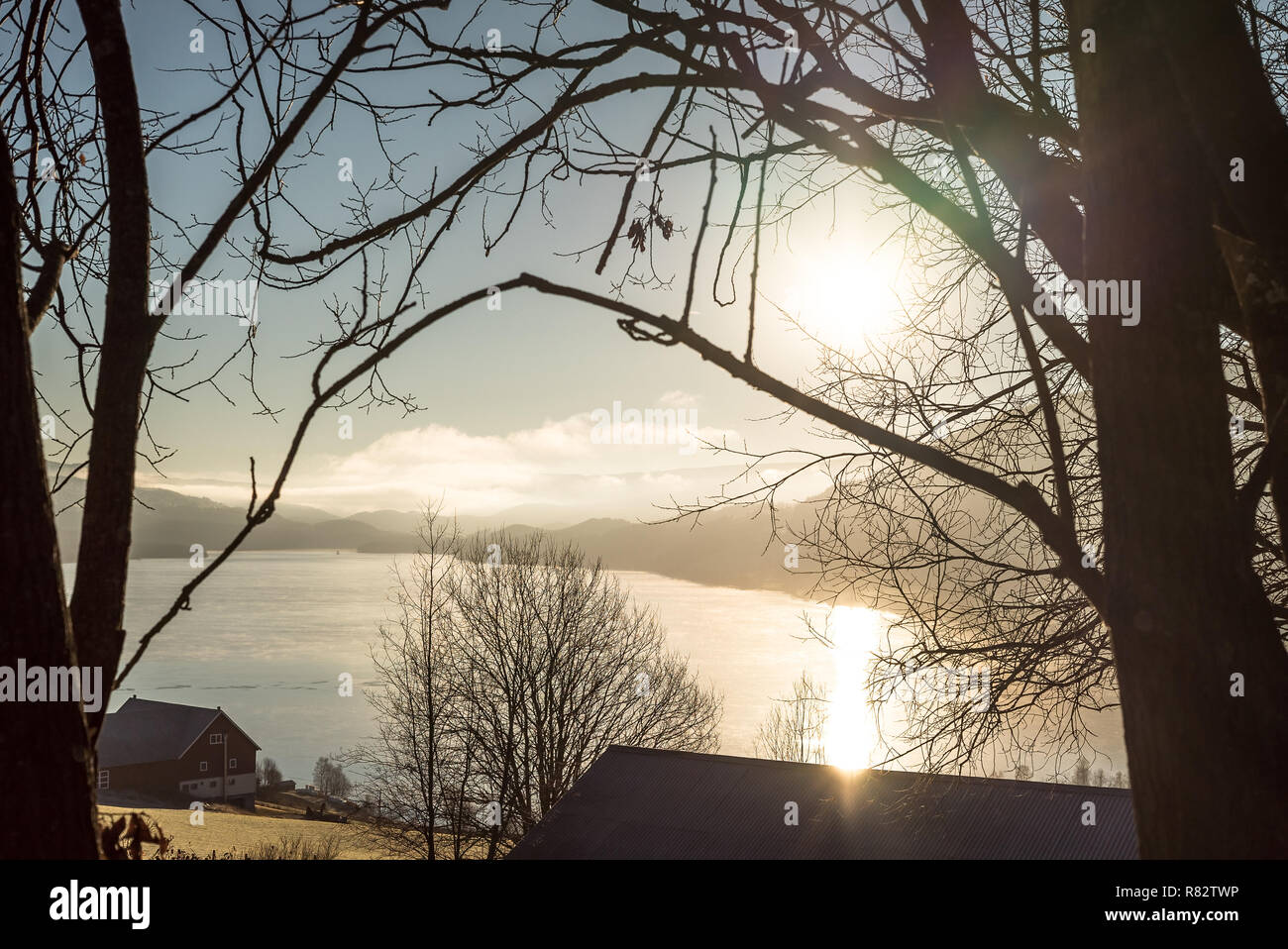 Ruhiger Sonnenaufgang über den See und die Landschaft auf einem kalten und Ruhigen Anfang Herbst morgen in der Landschaft mit den Bergen am Horizont Stockfoto