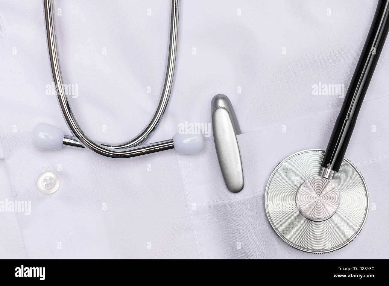 Stethoskop und Stift auf weißem Kittel Stockfoto