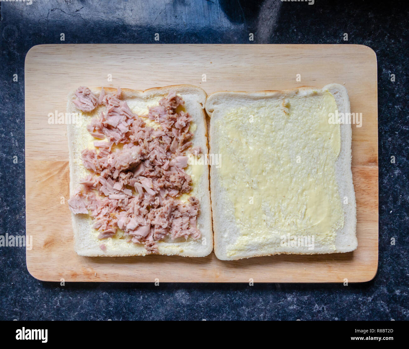 Butterbrot und mit Thunfisch Stücke auf einer hölzernen Schneidebrett wie ein Sandwich. Stockfoto