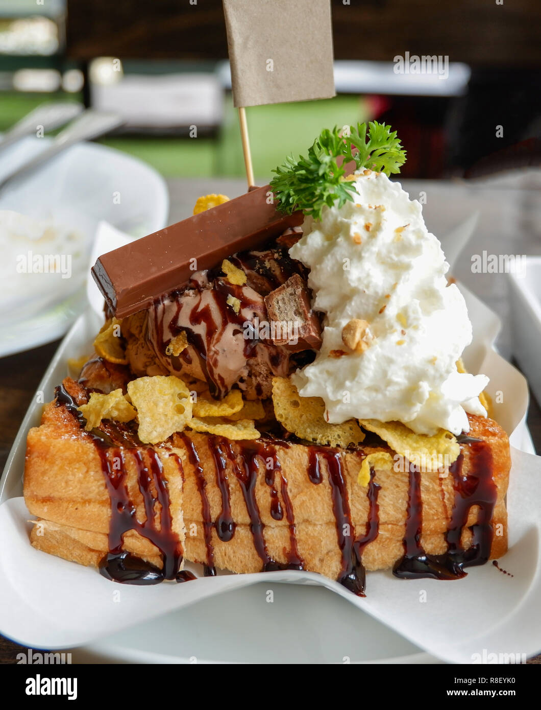 Honig santos Eis Dessert/Brot mit Schokolade Eis schaufeln Corn Flake Sahne Schokolade und Honig Biene auf weiße Platte im Cafe co Stockfoto