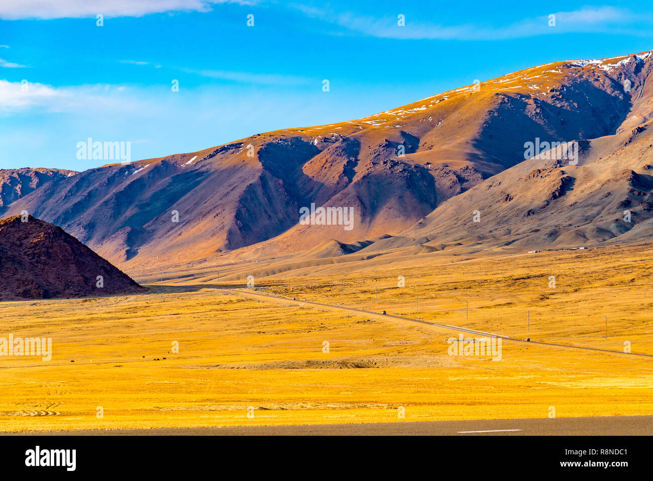 Die malerische Landschaft der westlichen Mongolei mit der Autobahn durch die grosse Steppe und der schönen hohen Berg an Ulgi Stockfoto