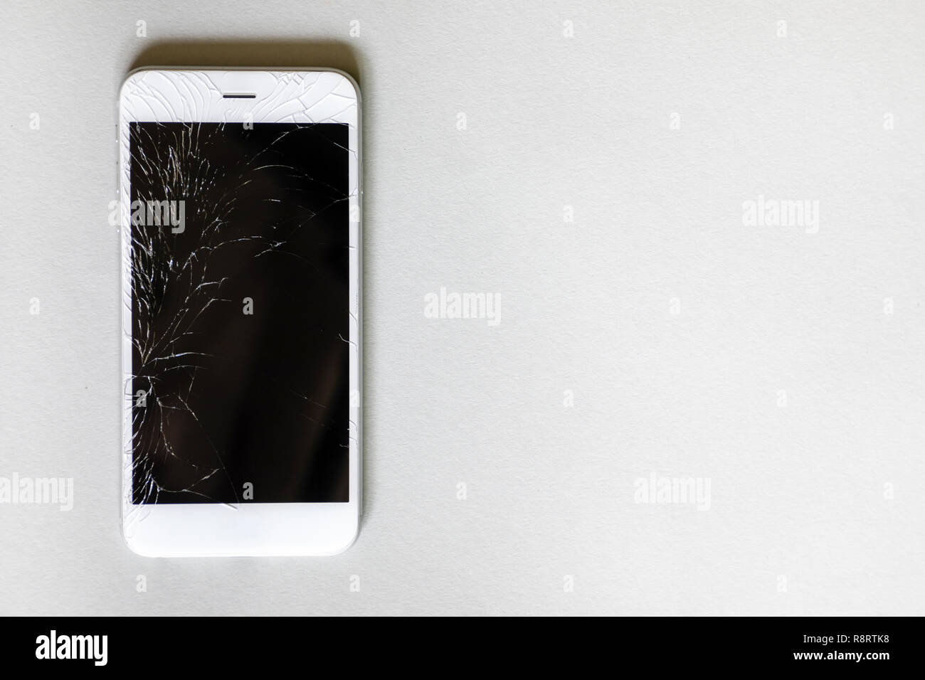 Mit defekten Bildschirm auf grauem Hintergrund Smartphone Stockfoto