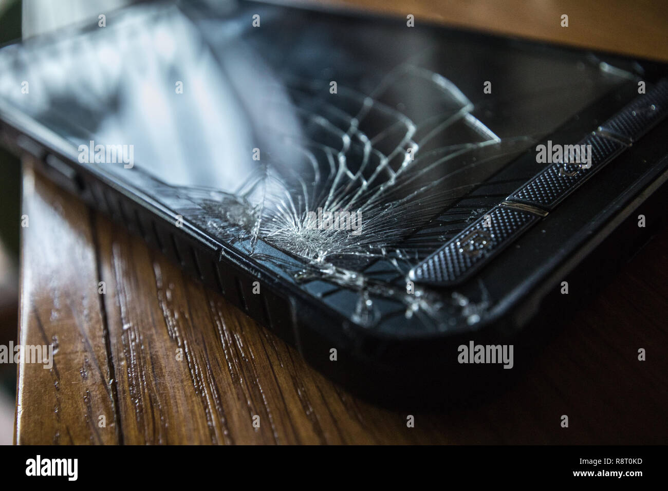 Risse Touchscreen Smartphone auf hölzernen Tisch Stockfoto