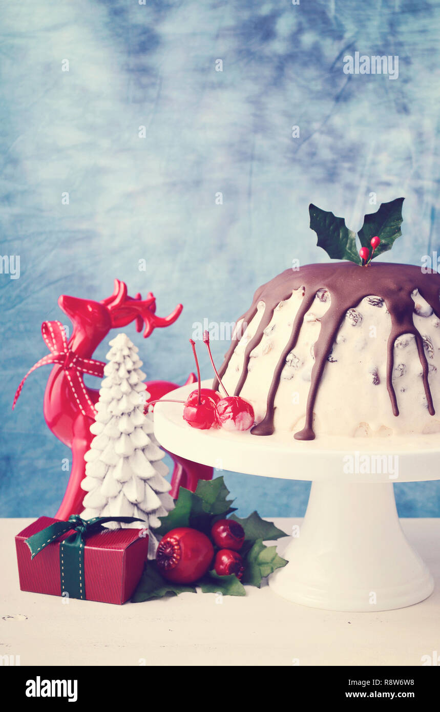 Sommer Weihnachten Eis Plum Pudding auf weißem Kuchen stand mit Rentier und Ornamenten, mit der angewandten retro Film Filter. Stockfoto