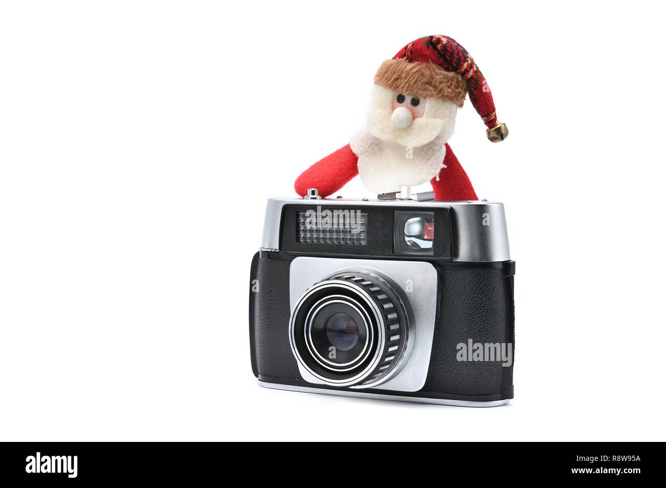 Santa Claus und vintage Kamera auf weißem Hintergrund isoliert für Silvester und Weihnachten. Santa Claus Fotograf nimmt Fotos und Pausen Stockfoto