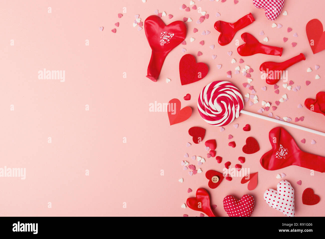 Schönen Valentines Tag Papier Herzen mit Luftballons und Bonbons auf rosa Hintergrund. Blick von oben. Valentines Tag Konzept. Stockfoto