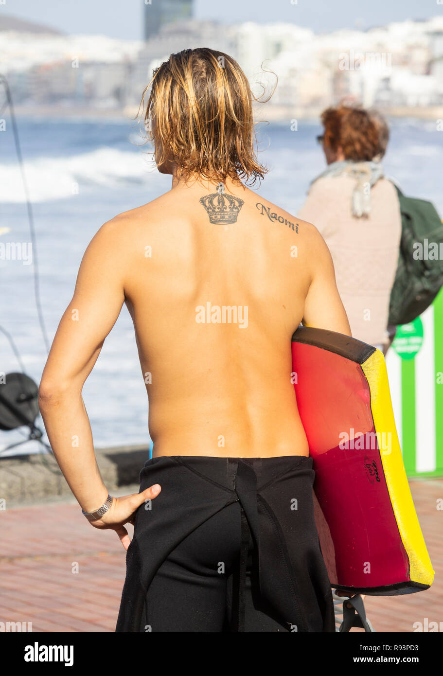 Ansicht der Rückseite des jungen Surfer Bodyboard tragen. Stockfoto