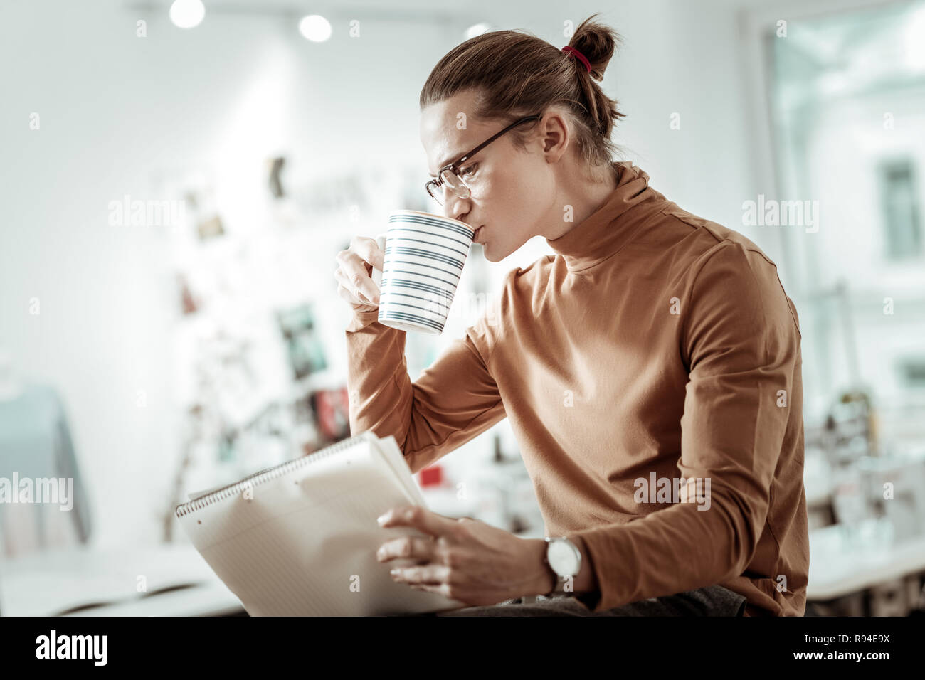 Blonde junge Designer aus Modeschule in schwarze Schuhe Kaffee Stockfoto