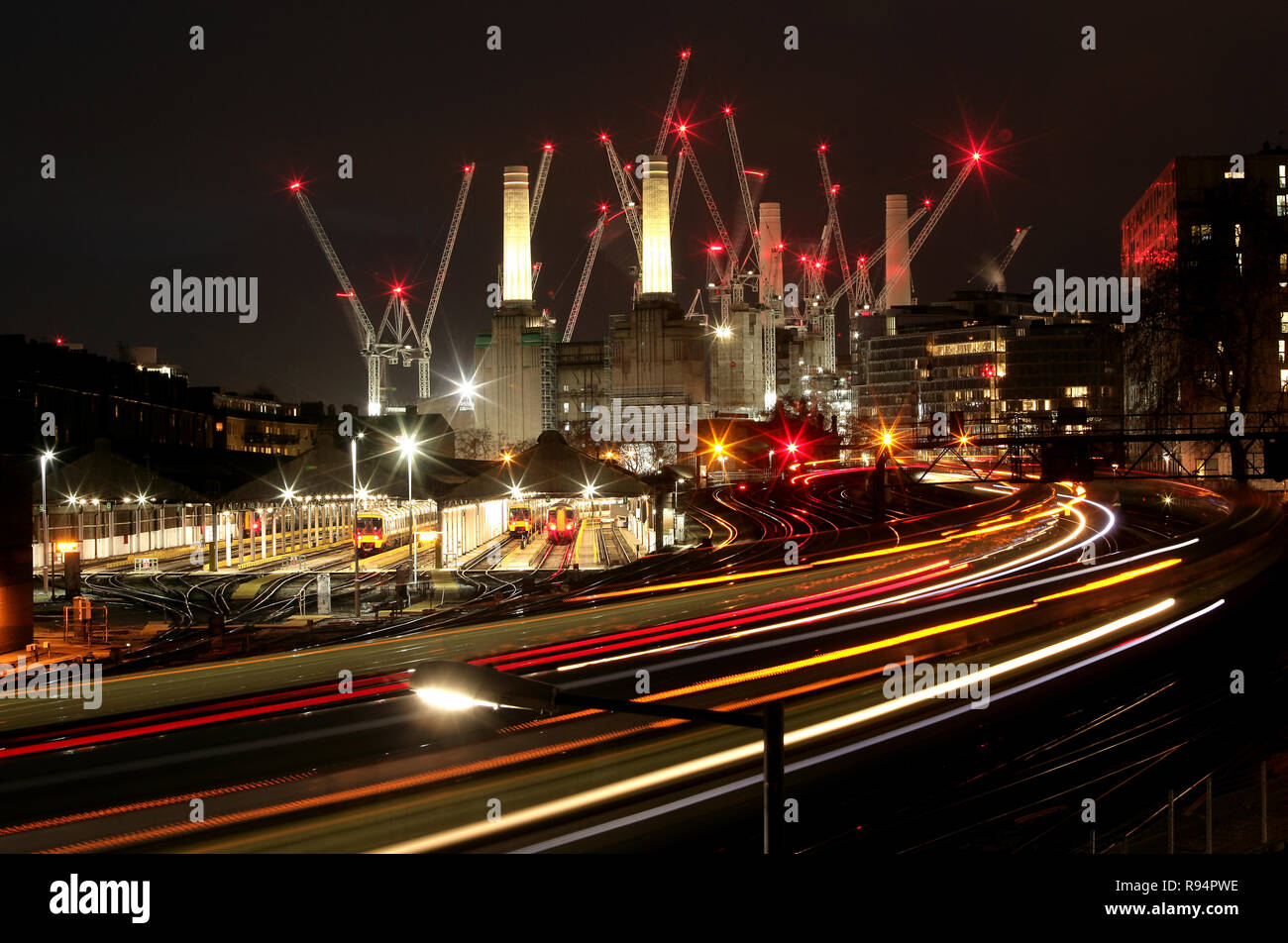 Battersea Power Station in der Nacht mit Kränen und Züge. Vom Bahnhof Victoria gesehen. Apple Campus. Stockfoto