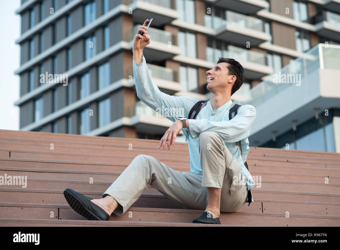 Schöner Mann unter selfie mit seinem Handy vor modernes Gebäude Stockfoto