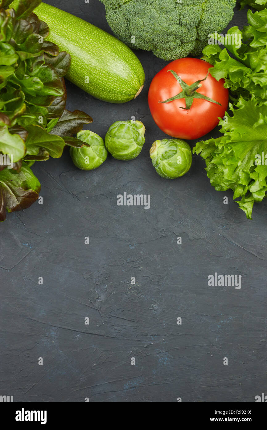 Gruppe von frischem Gemüse auf schwarzem Hintergrund. Es gibt Raum für Text in der Mitte. Copyspace. Stockfoto