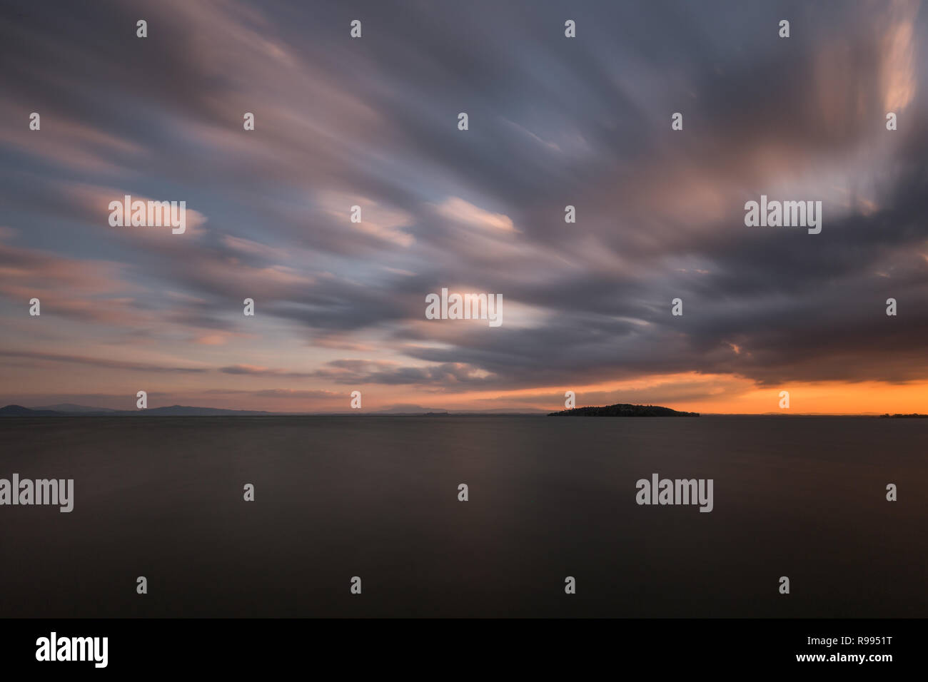 Schönen Weitwinkel, Langzeitbelichtung, Blick auf den See bei Sonnenuntergang, mit einem riesigen Himmel mit Wolken bewegen Stockfoto