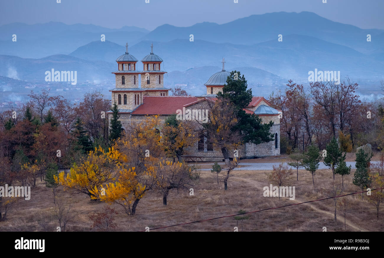 Laterale Ansicht von Shen Ilia (Saint Elia) Kirche auf einem Hügel in Korca Albanien im Herbst. Hintergrund Blick auf die Berge rund um die Stadt Stockfoto