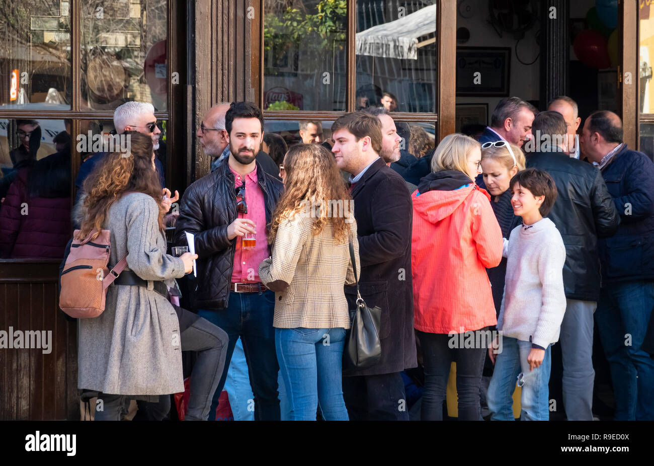 Freunde teilen Getränke und Gespräch vor einer Bar in Sevilla, Spanien Stockfoto