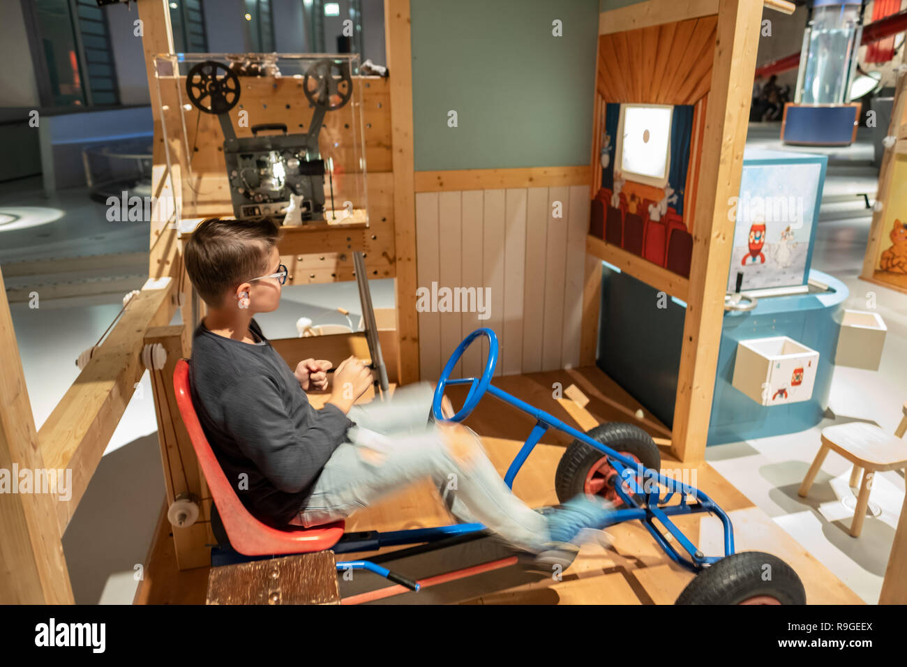 Wolfsburg, Deutschland. 23 Dez, 2018. Besucher Noel beginnt in der Sonderausstellung "Die Tüftelmäuse' im Science Museum Phaeno mit einem Go-Maus Film auf einem kleinen Bildschirm Kart. Mit dem 'Tüftelmäusen', die Ausstellung die Besucher eintauchen in eine Welt voller Fantasie, in der ihre erfinderischen Geist erwacht ist. In einem "Dachboden", sie erwarten zahlreiche interaktive Stationen, wo Sie ihren Einfallsreichtum beweisen können und ihre volle körperliche Engagement zeigen. Zusammen stellen sie die Maschinen in Bewegung mit Rädern, Gürtel und Zahnräder. Credit: Peter Steffen/dpa/Alamy leben Nachrichten Stockfoto