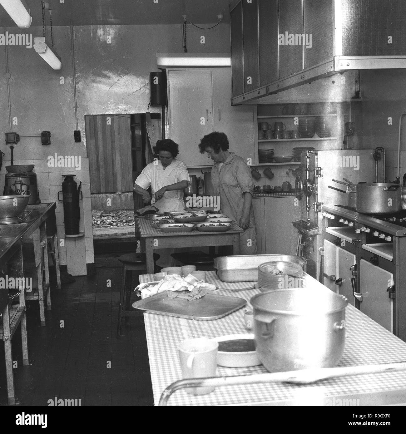 1968, South London, innerstädtischen jungen Boarding School, England, zwei Köchinnen in der Schule Küche, England, UK. Stockfoto