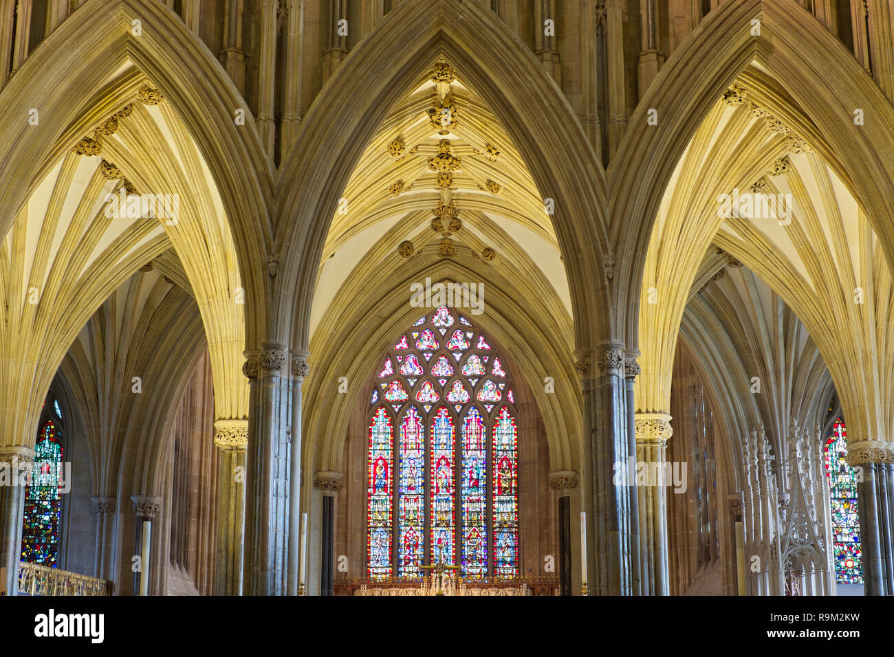 Detail der Torbögen, gewölbte Decken und Stain Glass in Wells Cathedral. Wells, Somerset, Großbritannien Stockfoto