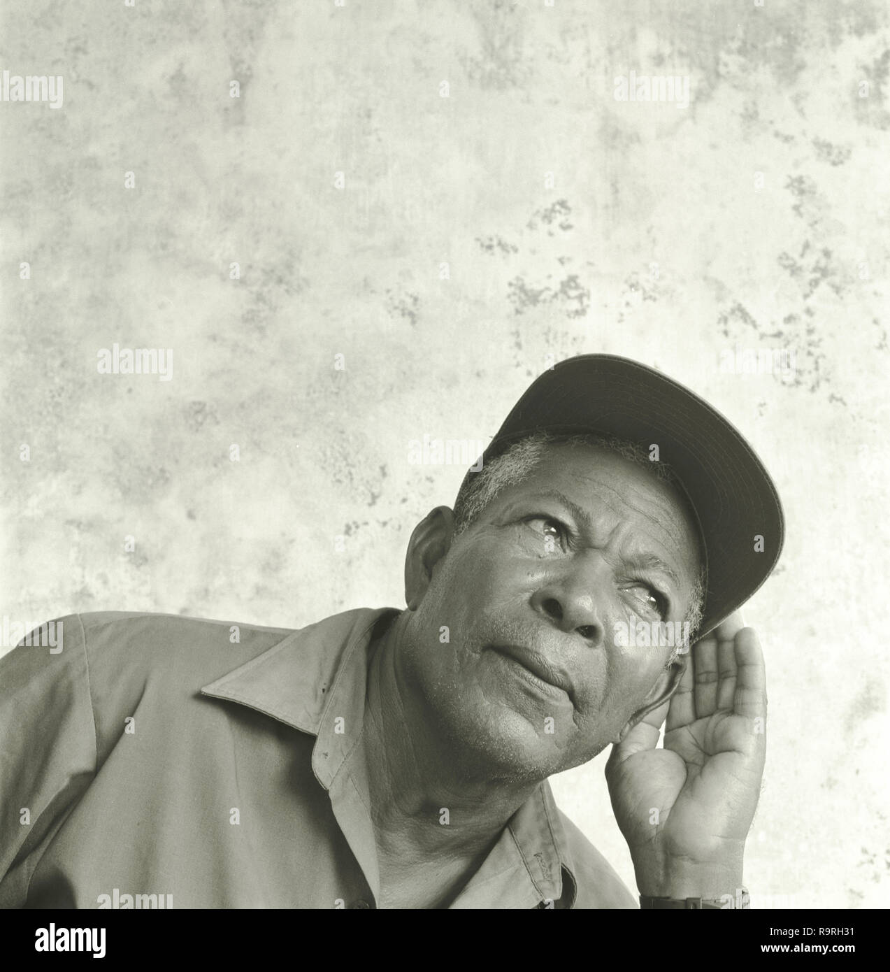 Vorderansicht eines älteren Mann, der versucht, genau hinzuhören. Stockfoto