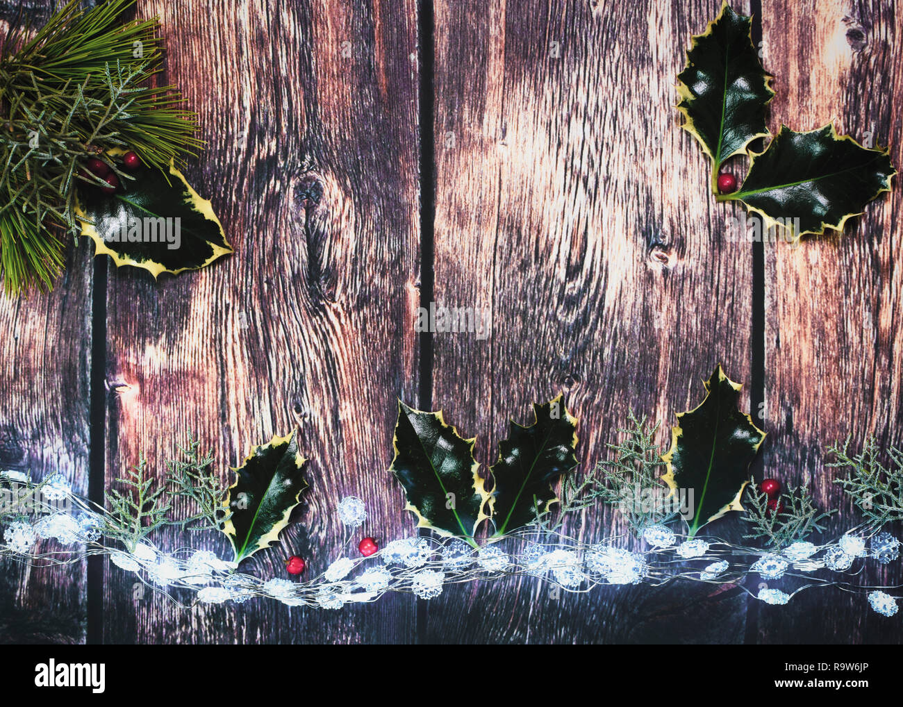 Hintergrund holly angezeigt, Holz- und Weihnachtsbeleuchtung Schuß für Kopie Raum über dem Kopf Bild ideal für Text über für Verkaufs- oder Poster legen Stockfoto