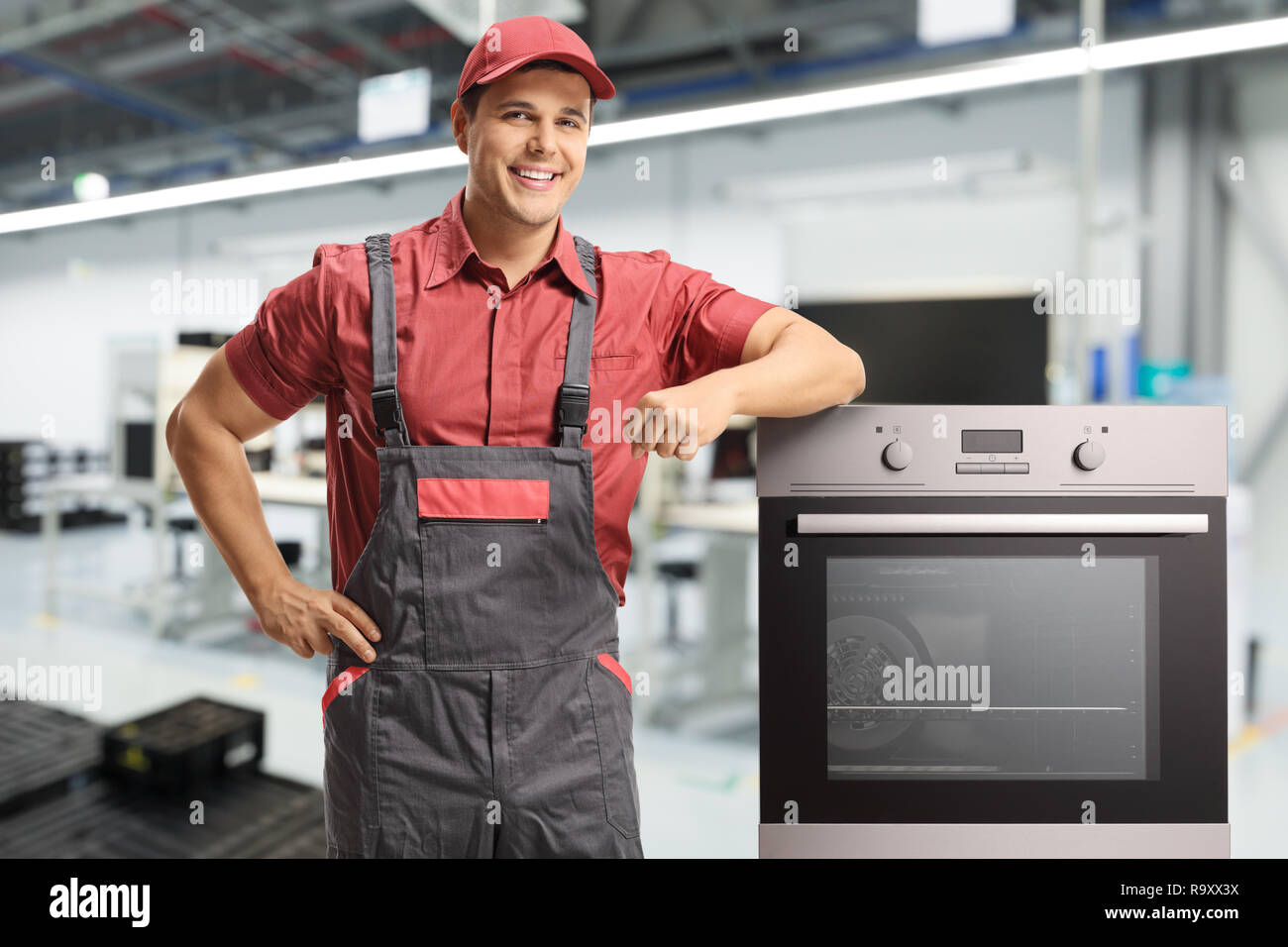 Männliche Arbeiter in einer einheitlichen stand neben einem elektrischen Ofen in einer Fabrik Stockfoto
