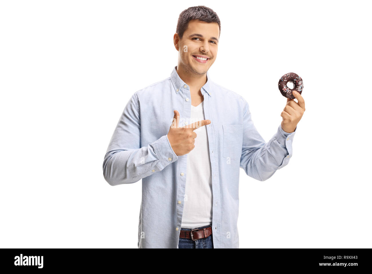Lächelnden jungen Mann, der auf einen Donut in der Hand auf weißem Hintergrund Stockfoto