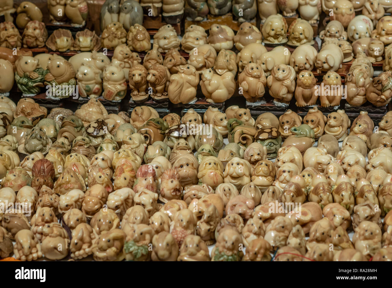 Kunstgegenstände aus Tagua Nuß in Hong Kong's Jade Market Stall. Die Mutter, die oft als "Pflanzliches Elfenbein", ist in Tiere, Verzierungen geschnitzt, und Glücksbringer. Stockfoto