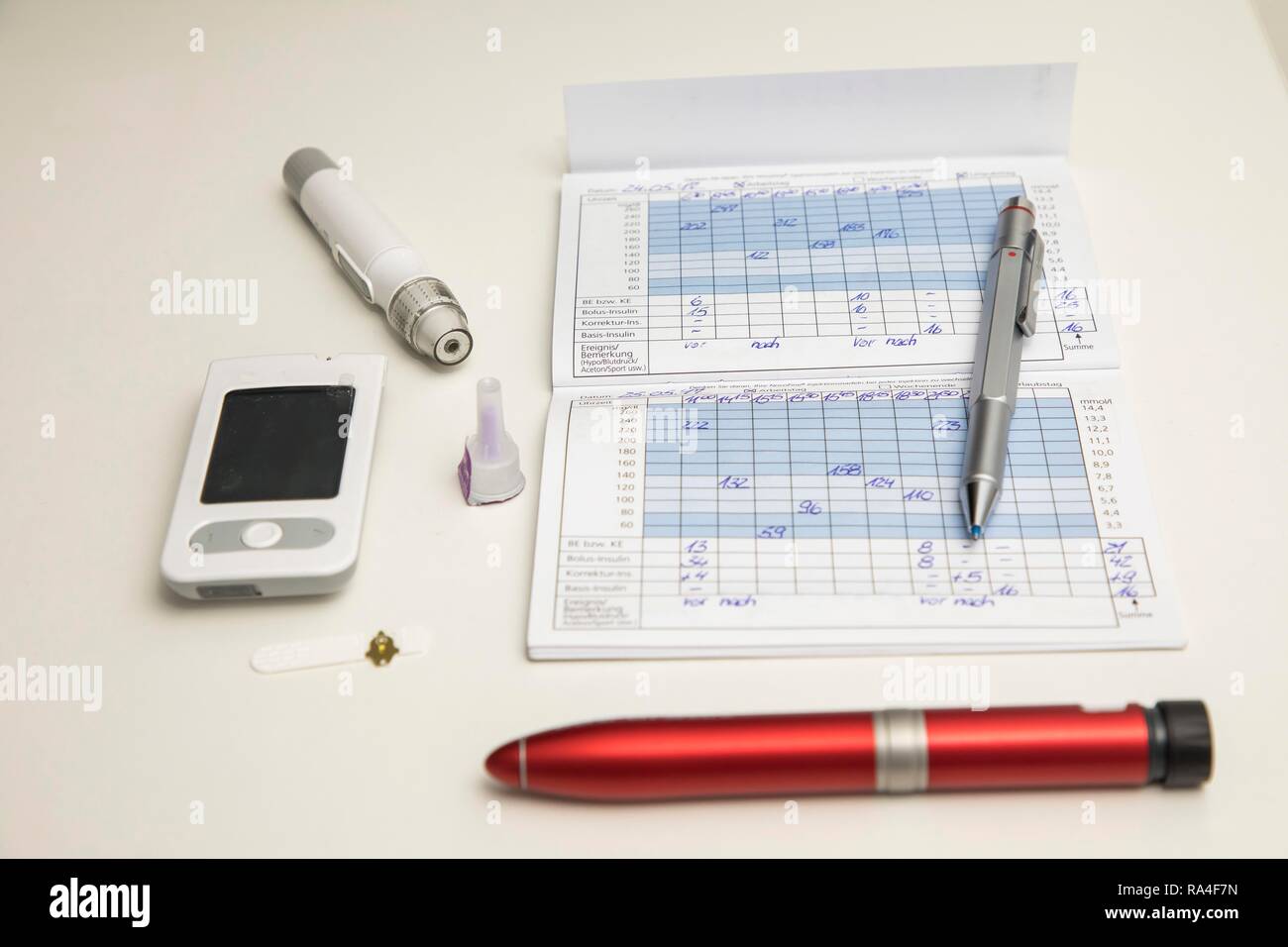 Diabetes, links Blutzuckermessgeräte, Teststreifen und Stechhilfe, Insulinpen, Blutglukose Tagebuch, Deutschland Stockfoto