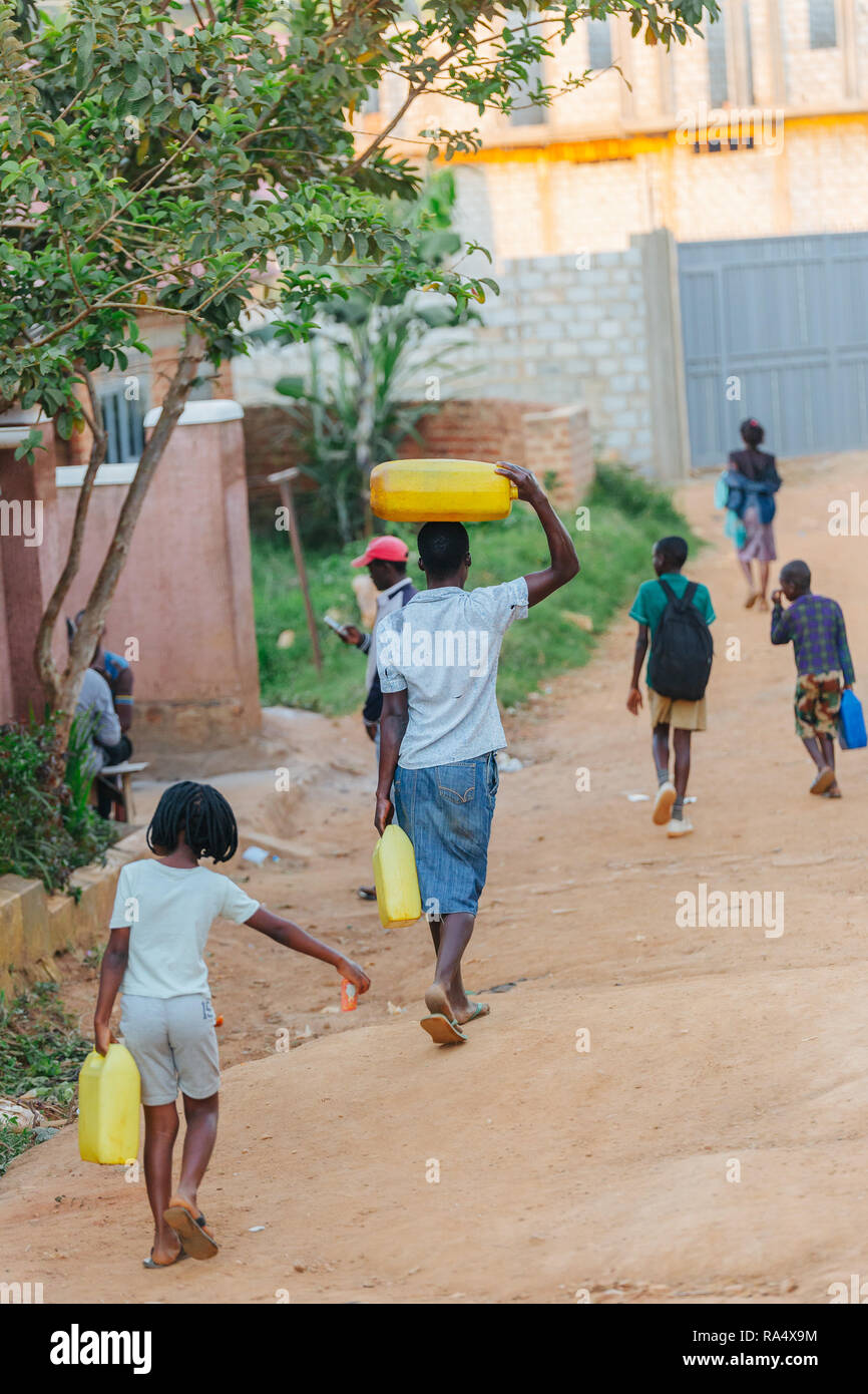 Frau, die Wasser in Entebbe, Uganda, trägt Stockfoto