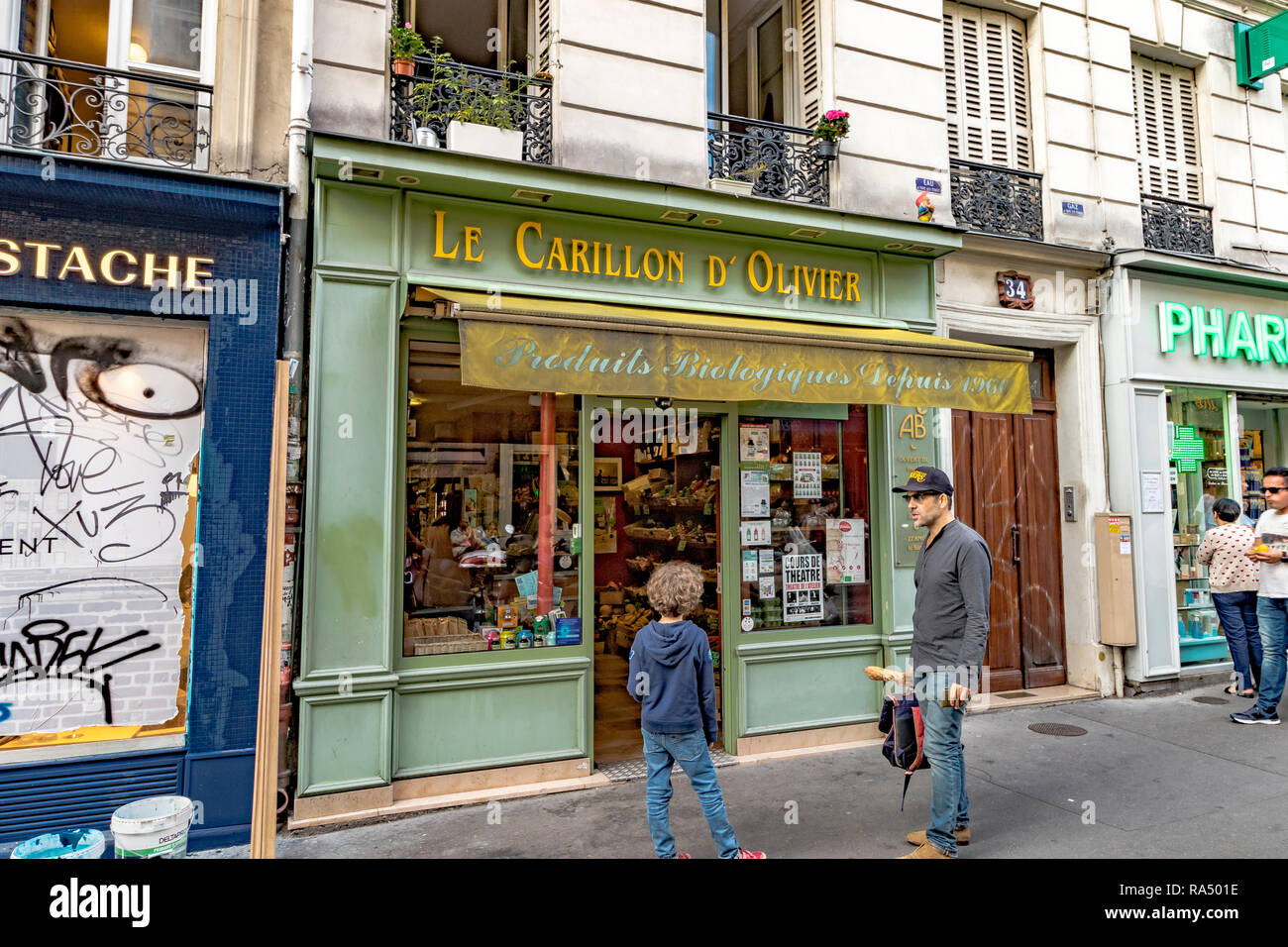 Ein Mann und eine junge Stand außerhalb Le Carillon D'Olivier ein Obst und Gemüse Laden in der Rue des Abbesses, Paris Stockfoto