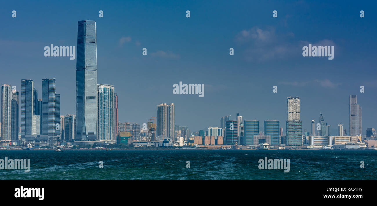 Die Wolkenkratzer von West Kowloon und Tsim Sha Tsui line Victoria Harbour in Hong Kong Stockfoto