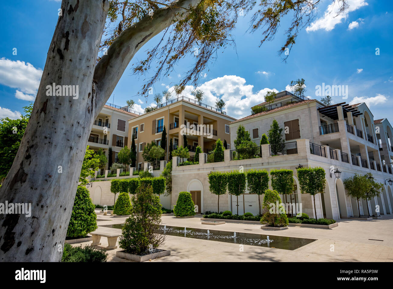 TIVAT MONTENEGRO - 16. MAI 2017: Luxus Wohngebäude an der Küste der Adria gebaut. Sonnige ruhige Frühling und Straße mit fountai Stockfoto
