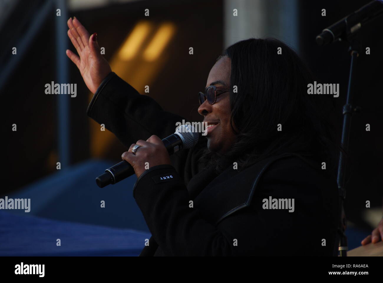 Oakland, Kalifornien, USA. 1 Jan, 2019. Oscar Grant Mutter, Wanda Johnson, singt bei einer Mahnwache außerhalb der Fruitvale BART-Station in Oakland, Kalifornien, Kennzeichnung der zehnte Jahrestag seit er erschossen wurde und von einem Polizisten getötet. Credit: Scott Morris/Alamy leben Nachrichten Stockfoto