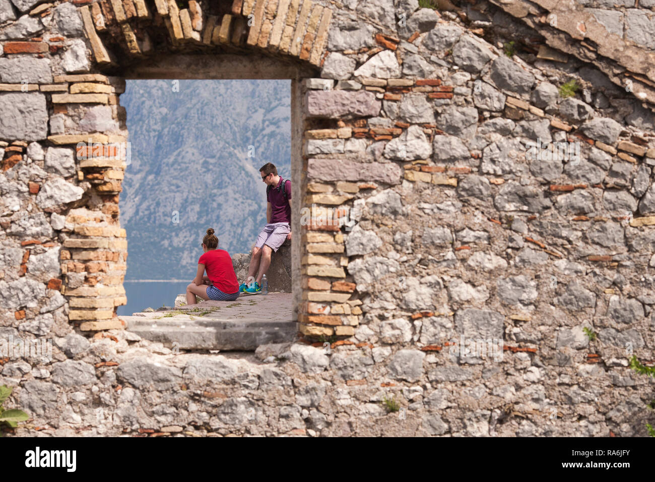 Touristen ruhen und sehen von den Befestigungsanlagen über der Bucht aus den Blick über Kotor. Kotor. Montenegro Stockfoto