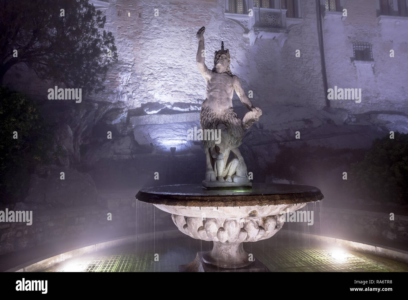 Statue im Garten des alten Klosters verwandelt sich in eine Burg, die im Nebel getaucht, Cison di Valmarino, Italien Stockfoto