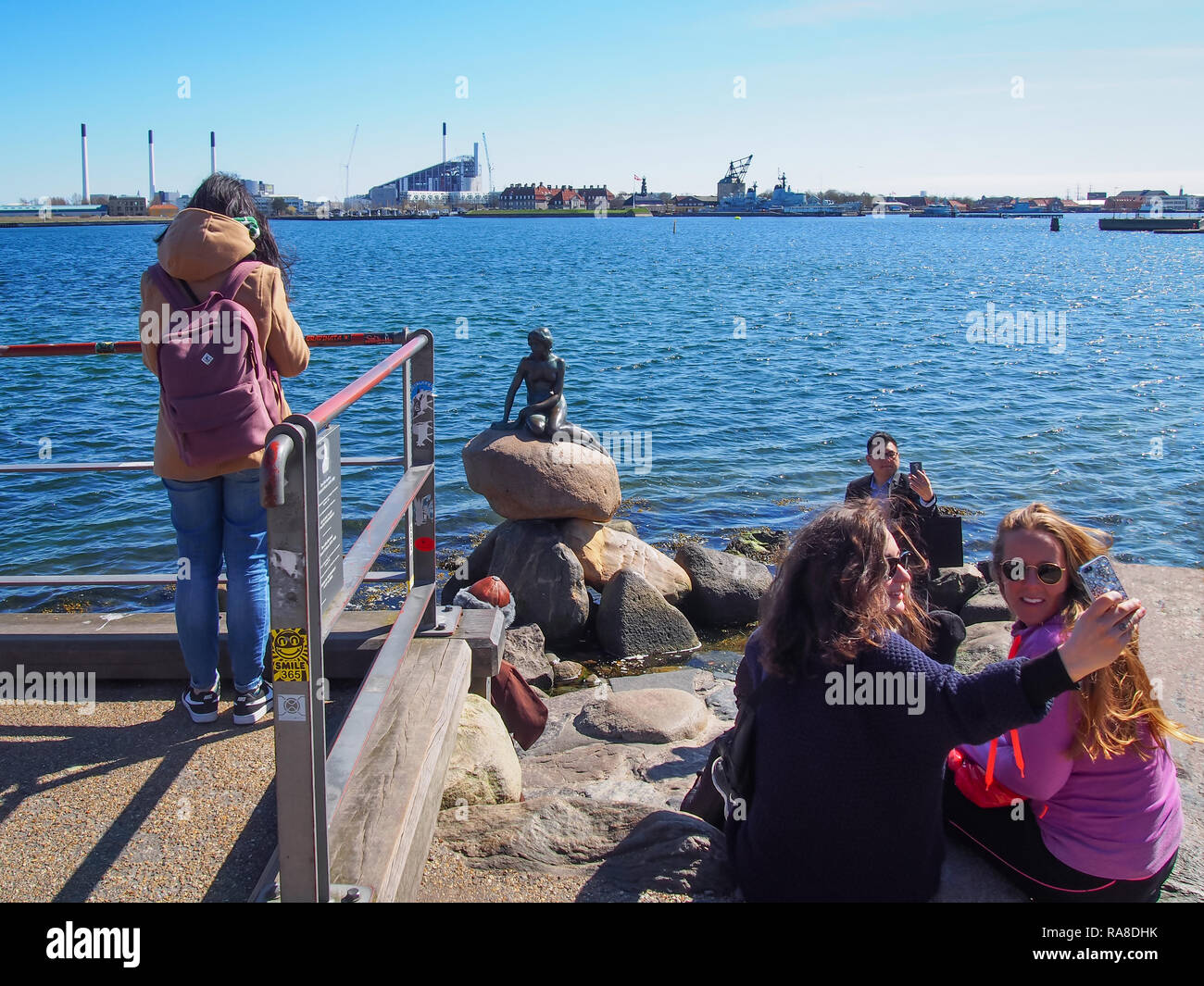 Kopenhagen, Dänemark - 11 April 2016: Touristen selfies auf dem Bronze Statue der Kleinen Meerjungfrau von Edvard Eriksen Stockfoto