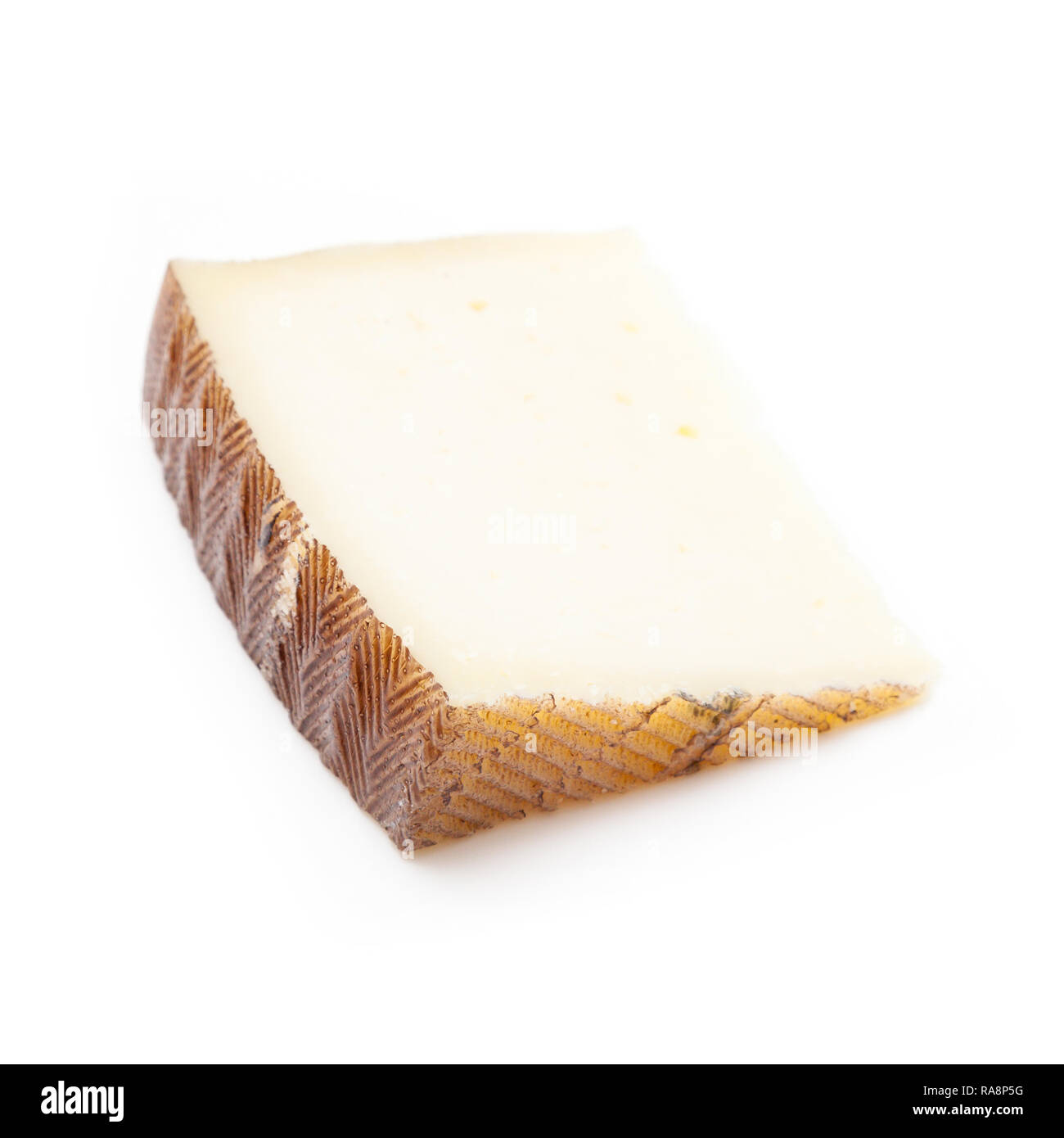 Spanischer Manchego Käse aus Schafsmilch hat es eine feste und cremige Textur, auf einem weißen studio Hintergrund isoliert. Stockfoto