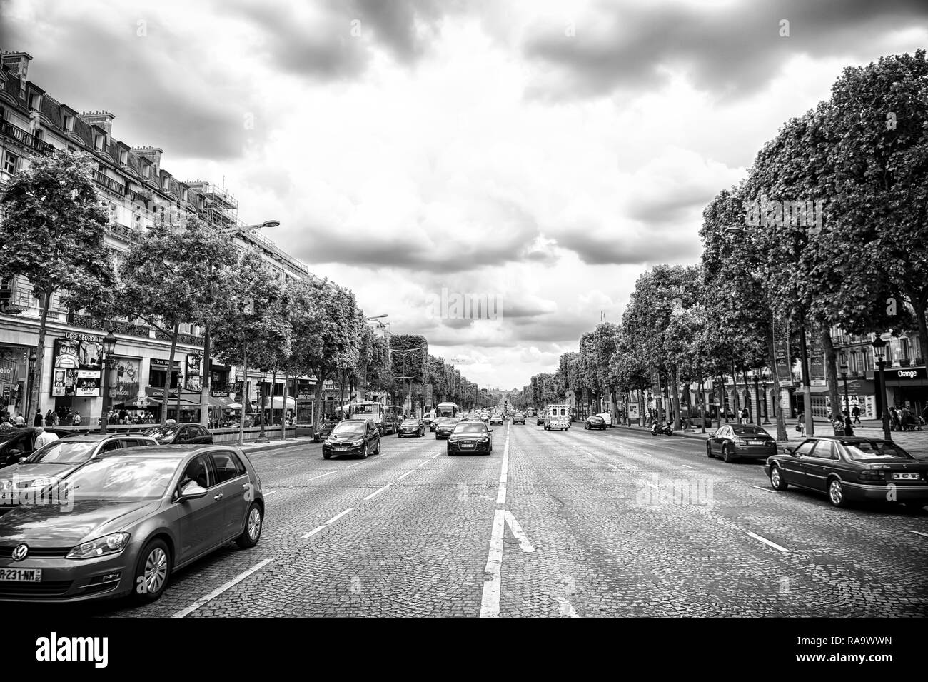 Paris, Frankreich - Juni 02, 2017: Avenue des Champs Elysees mit viel Verkehr. Elysian Fields Road an bewölkten Himmel. Urlaub und Reisen in die französische Hauptstadt. Stockfoto